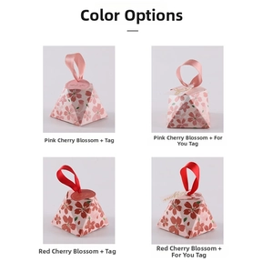 Detailed macro view of pyramid-shaped cherry blossom candy gift boxes with silk ribbon handles