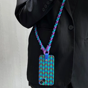 Detail of woven purple and turquoise phone strap with geometric pattern case on black blazer