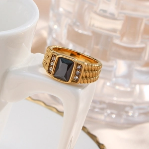 Close-up of 18K gold plated ring featuring black square zircon and scale texture