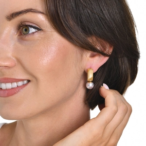 Elegant gold knotted hoop earrings with pearl pendant shown on a model for a vintage look
