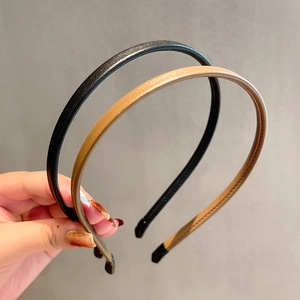 Minimalist leather hairbands in black and caramel brown with soft protective tips