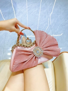 Pink pleated evening bag with crystal floral brooch and gold metal handle for women