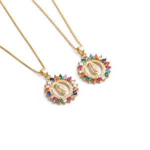 Golden pendant necklace with colorful zircon gemstones and embossed circular design