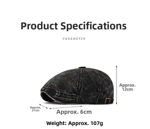 Detailed view of washed black denim flat cap showing bronze metal buckle and dimensions
