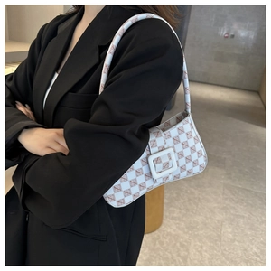 Detail shot of vintage monogram underarm bag with white square buckle and leather strap