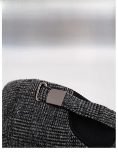 Detail of adjustable metal buckle on grey plaid winter baseball cap for senior men