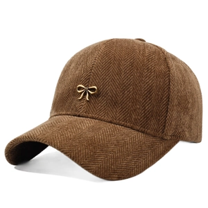 Stylish brown herringbone baseball cap with a decorative gold metal bow for women