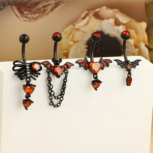Set of four gothic belly rings featuring bat, skeleton ribs, and coffin pendants in black