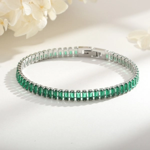 Macro detail of 6mm tennis bracelet with 18K gold-plated baguette cut green zircon stones