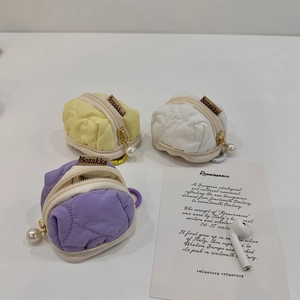 Quilted mini earphone pouches in yellow, white, and purple with pearl zipper charms