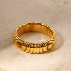 Polished 18K gold snake bone texture bangle with classic Tubogas flexible metal structure