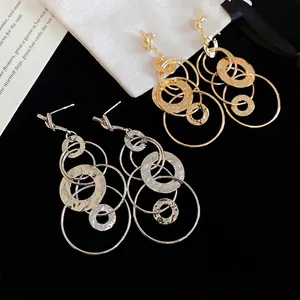 Knotted multi-layered gold and silver drop earrings with geometric hammered metal rings