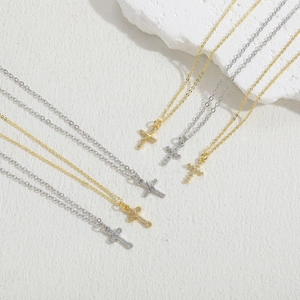 Macro shot of gold and silver cross pendants with shimmering cubic zirconia stones