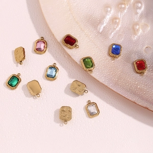 Macro detail of colorful rectangular pendants with golden bases and hammered textures