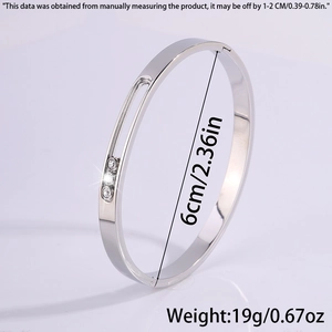Detail of silver titanium bangle with three sliding zircons including size and weight specs