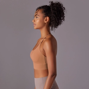 Detail view of khaki sports bra and purple high-waist yoga leggings set on studio model