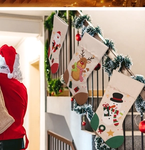 Detail of Christmas stockings with Santa and reindeer patterns on festive stairs