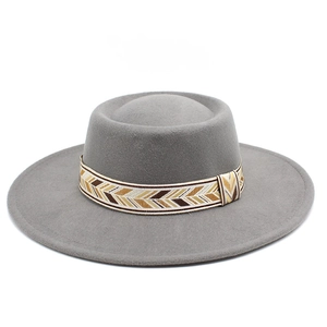 Detailed view of grey wool felt fedora featuring a tribal pattern braided hat band