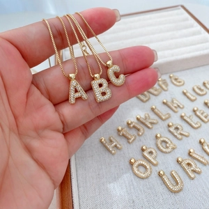Golden alphabet pendant necklace set with sparkling cubic zirconia letter charms A to Z