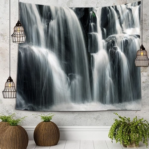Detail of wall tapestry featuring black and white waterfall landscape on textured wall