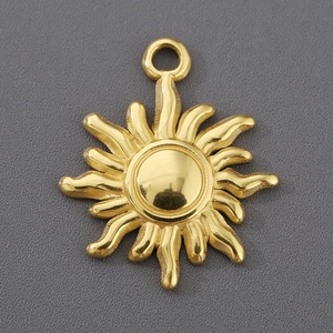 Macro detail of a golden sun-shaped pendant with smooth metallic finish for DIY jewelry