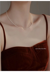 Macro shot of 2mm ultra-fine mini silver bead choker on a model for a minimalist style