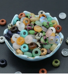 Assorted natural crystal agate stone beads in a blue bowl for DIY jewelry making