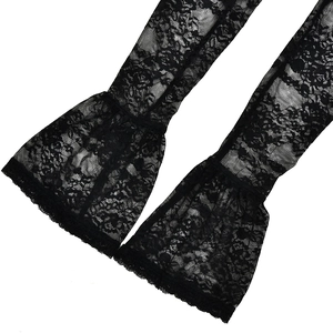 Detailed view of long black lace flare sleeves with delicate floral patterns on white background