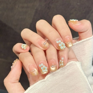 Exquisite champagne gold gradient press-on nails with 3D blue flowers and pearl accents