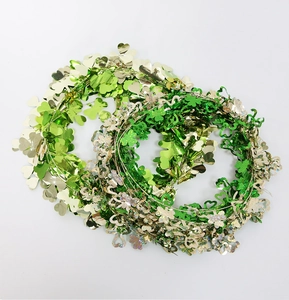 Close-up of St. Patrick's Day garland with metallic green and gold shamrock sequins