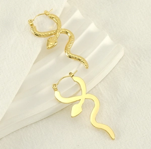 Detail of 18k gold plated snake earrings with contrasting scale texture and mirror finish
