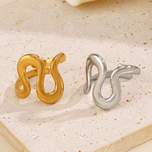 Irregular wavy open rings in gold and silver finish on a natural stone base