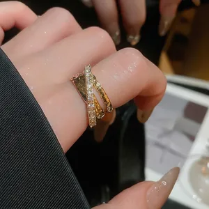 Three-layer crisscross open ring with pavé zircons and textured gold bands for women