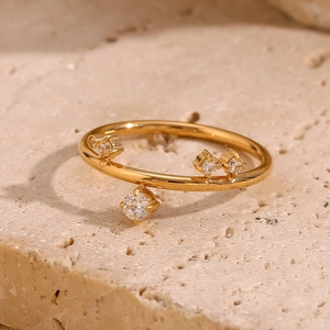 Detail of 18K gold plated crown ring with micro-set white zircons and hanging charm