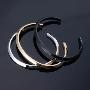 Three-piece minimalist C-shaped open bracelets in gold, silver, and black stainless steel