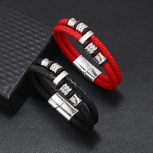 Detail of red and black braided leather bracelets with silver magnetic metal clasps