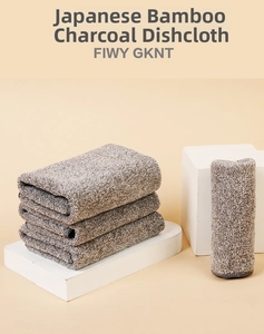Detailed texture of thick charcoal fiber dishcloths stacked on a white display stand