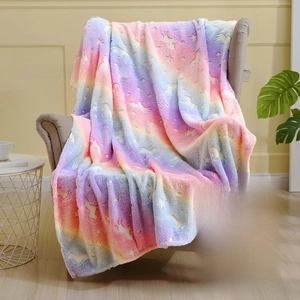 Close-up of glow-in-the-dark flannel blanket with unicorn stars on a gray chair