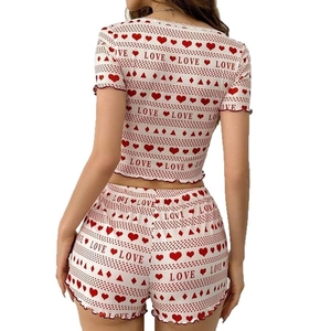 Two-piece ribbed knit pajama set with red heart and 'LOVE' print featuring ruffled edges