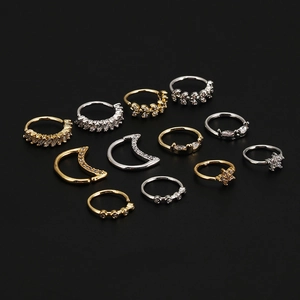 Anneaux de nez 20G zircon étoile lune fleur en or et argent sur fond noir élégant