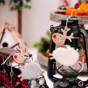 Detail of plush Christmas reindeer ornaments with wooden legs and festive red bows