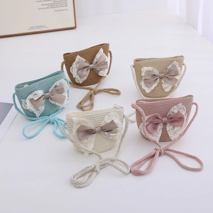 Set of five children's woven straw bags with lace trim and silk bows in various colors