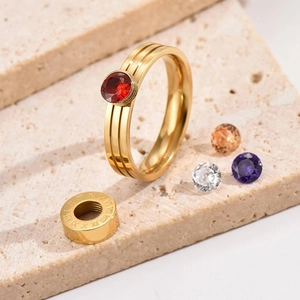 Anello dorato con numeri romani e pietre di zircone intercambiabili in vista a 45 gradi