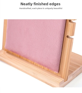 Close-up of pink velvet jewelry display stand with natural bamboo frame and side notches