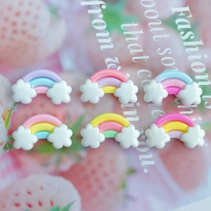 Detailed view of colorful rainbow and cloud resin charms for DIY craft decorations