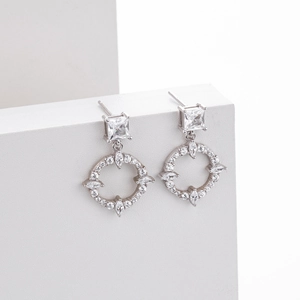 Detailed macro view of S925 sterling silver earrings with sparkling cubic zirconia stones