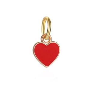 Close-up of heart-shaped red enamel charm with golden metal frame for DIY jewelry making