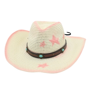 Detail of pink tie-dye straw cowboy hat with turquoise leather band and star motifs