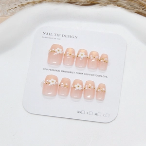 Handmade cat eye press-on nails with pearl floral accents and glossy pink finish