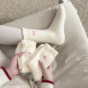 Creamy white plush thermal socks for women with delicate pink bow embroidery details